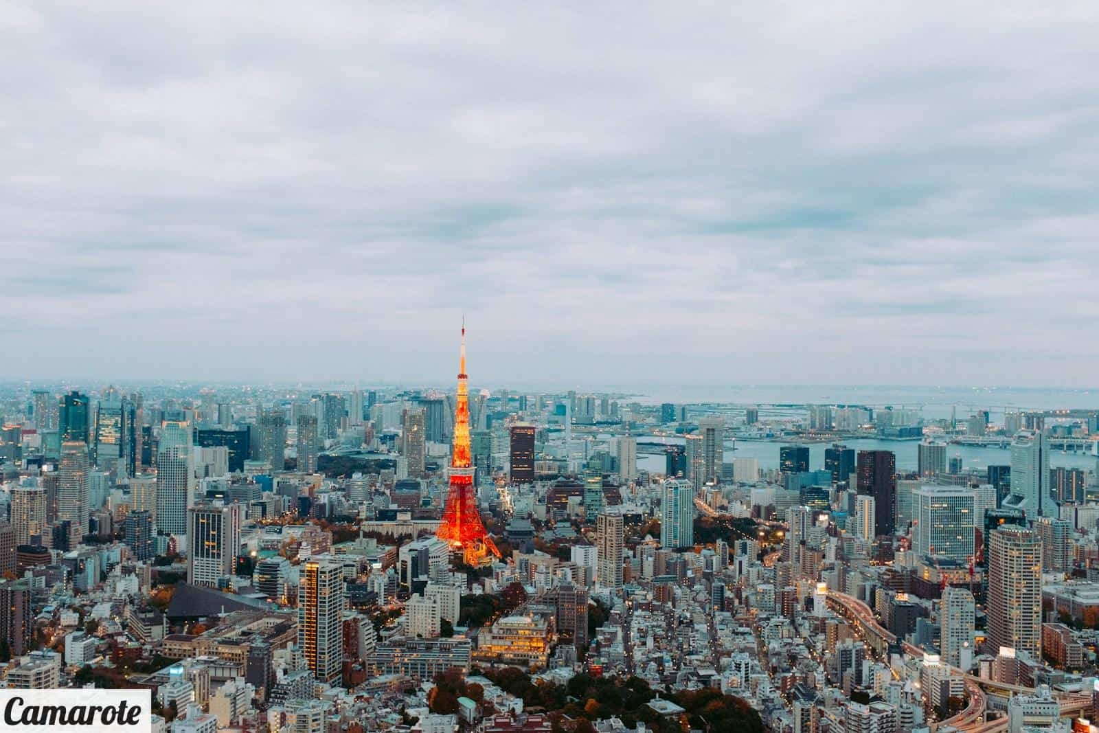 a view of a city with a red and yellow tower