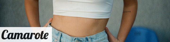 woman in white tank top and blue denim jeans