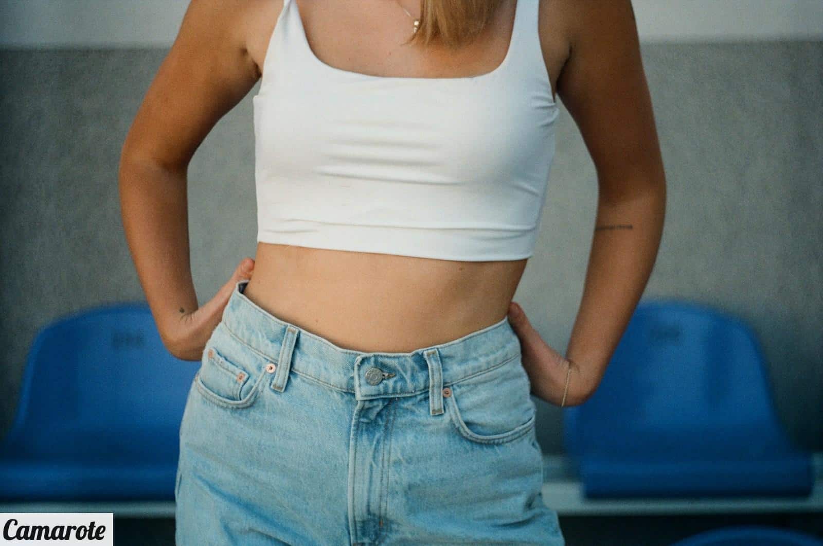 woman in white tank top and blue denim jeans